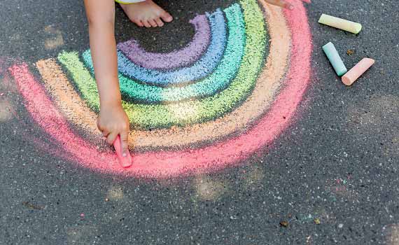 Image of a child drawing a rainbow on a sidewalk, which is also on the cover of the report. 