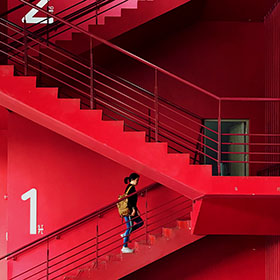 person climbing red stairs