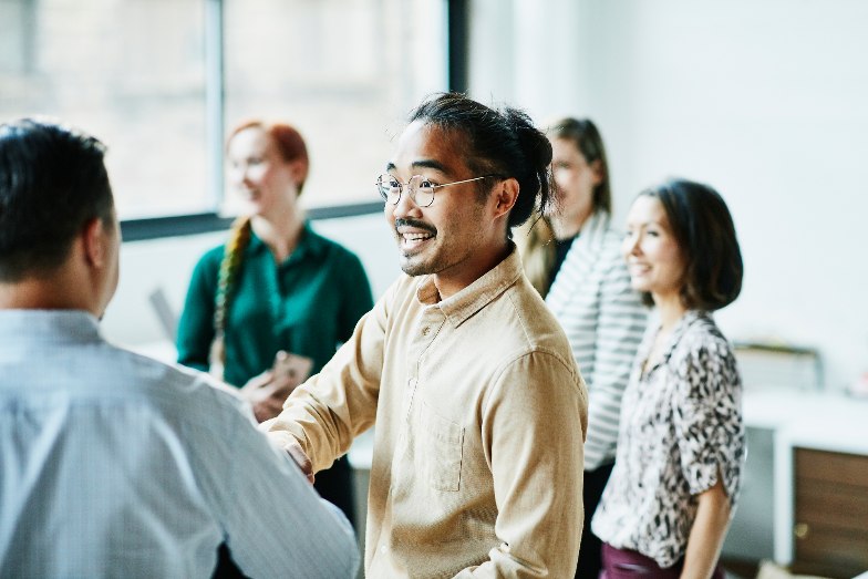 Businessman shaking hands with colleague after meeting in office