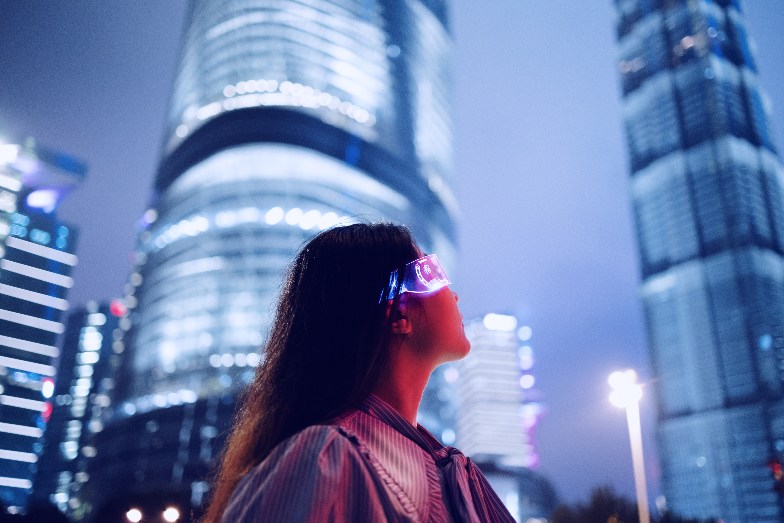 Person looking upwards at skyscrapers wearing smart glasses
