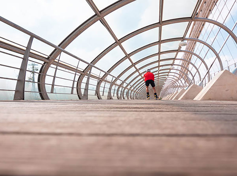 person skating down glass tunnel