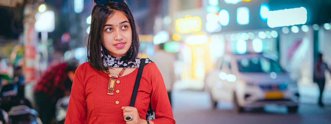 Young person in bright, blurred urban setting 