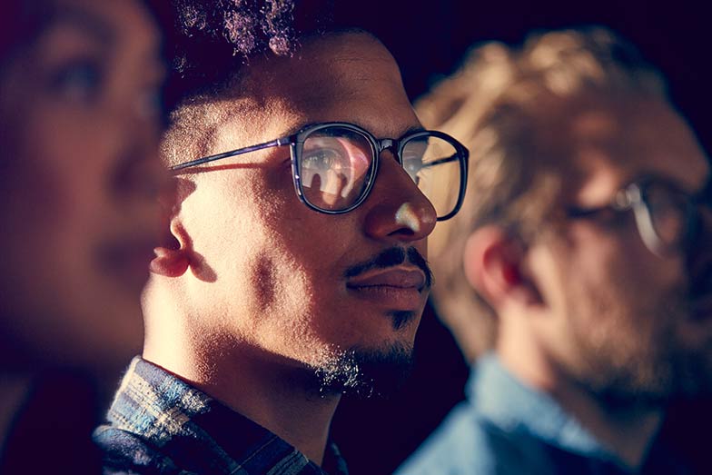 man wearing glasses and watching a video