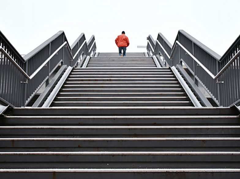 person walking to top of stairs