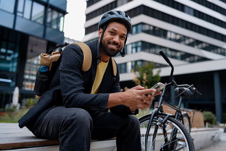 Person sitting on steps in urban setting with a bike