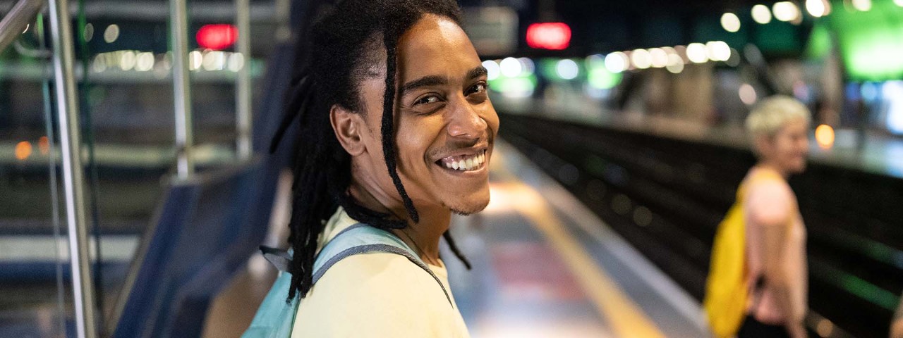 Person smiling to camera at train station