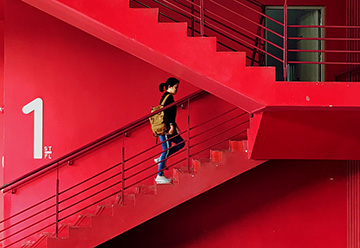 Person climbing red stairs