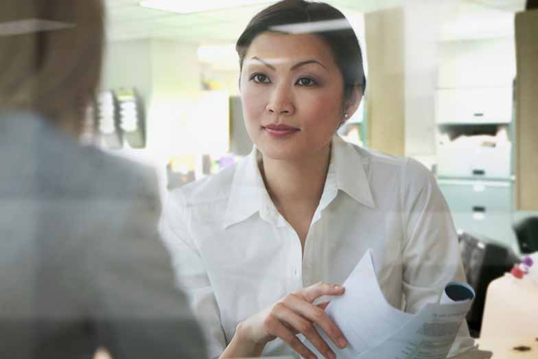 factory workers at computer screen
