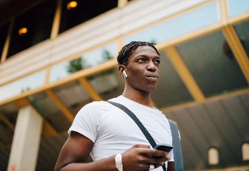 young person on mobile looking skywards