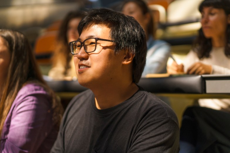 smiling student seated in lecture hall