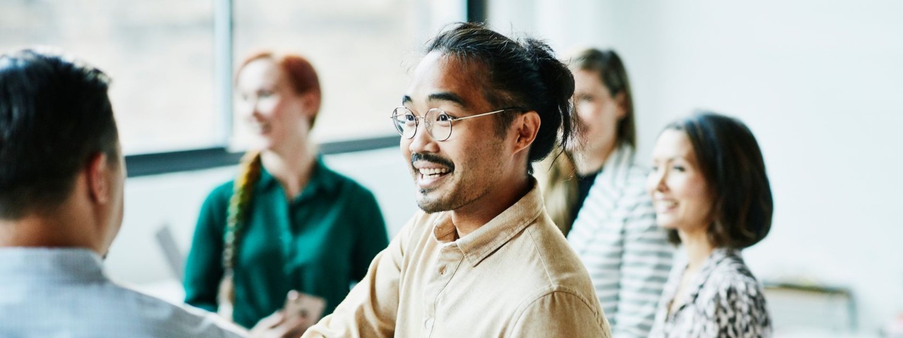 Business person shaking hands with colleague after meeting in office