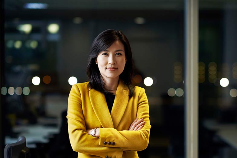 woman in business attire folding arms