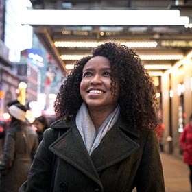 woman looking up and smiling in an urban setting