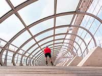 Person rollerblading across a glass-covered structure
