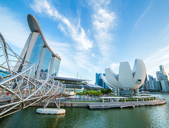 View of pedestrian Helix Bridge linking to Marina Bay Hotel and other buildings in the business district in Marina Bay, Singapore