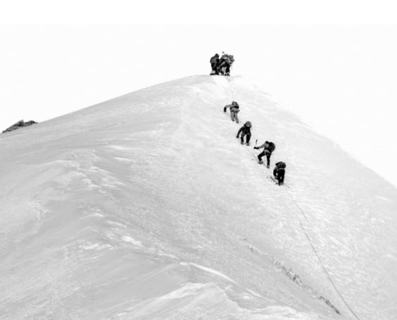 Rock climbers metaphorically climbing a mountain to symbolise the call for improved UN Sustainable Development Goals disclosures.