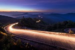 Traffic lights on a busy road in the dark