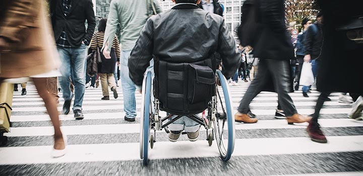 People on their way to work on a busy street crossing