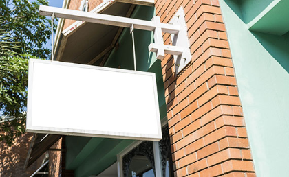 The exterior of an office, with a blank hanging company name sign