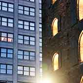 Night time image of traditional and modern buildings