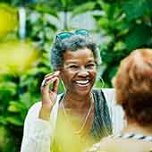 Two women women in happy conversation outdoors