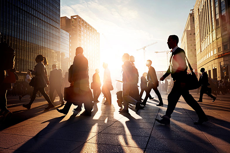 persons walking in city at dusk