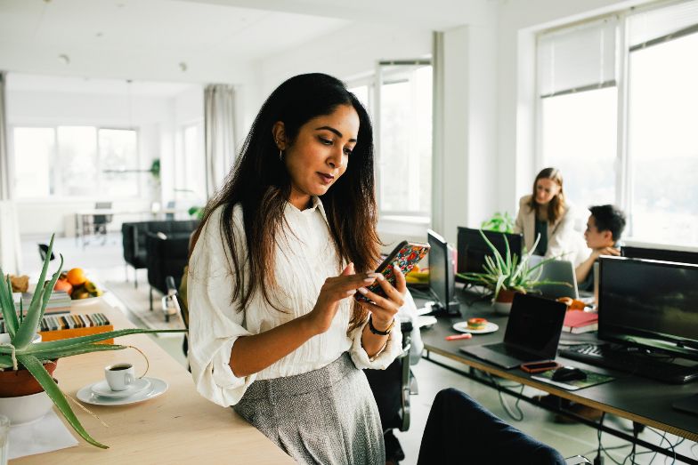 young professional using mobile phone in modern office