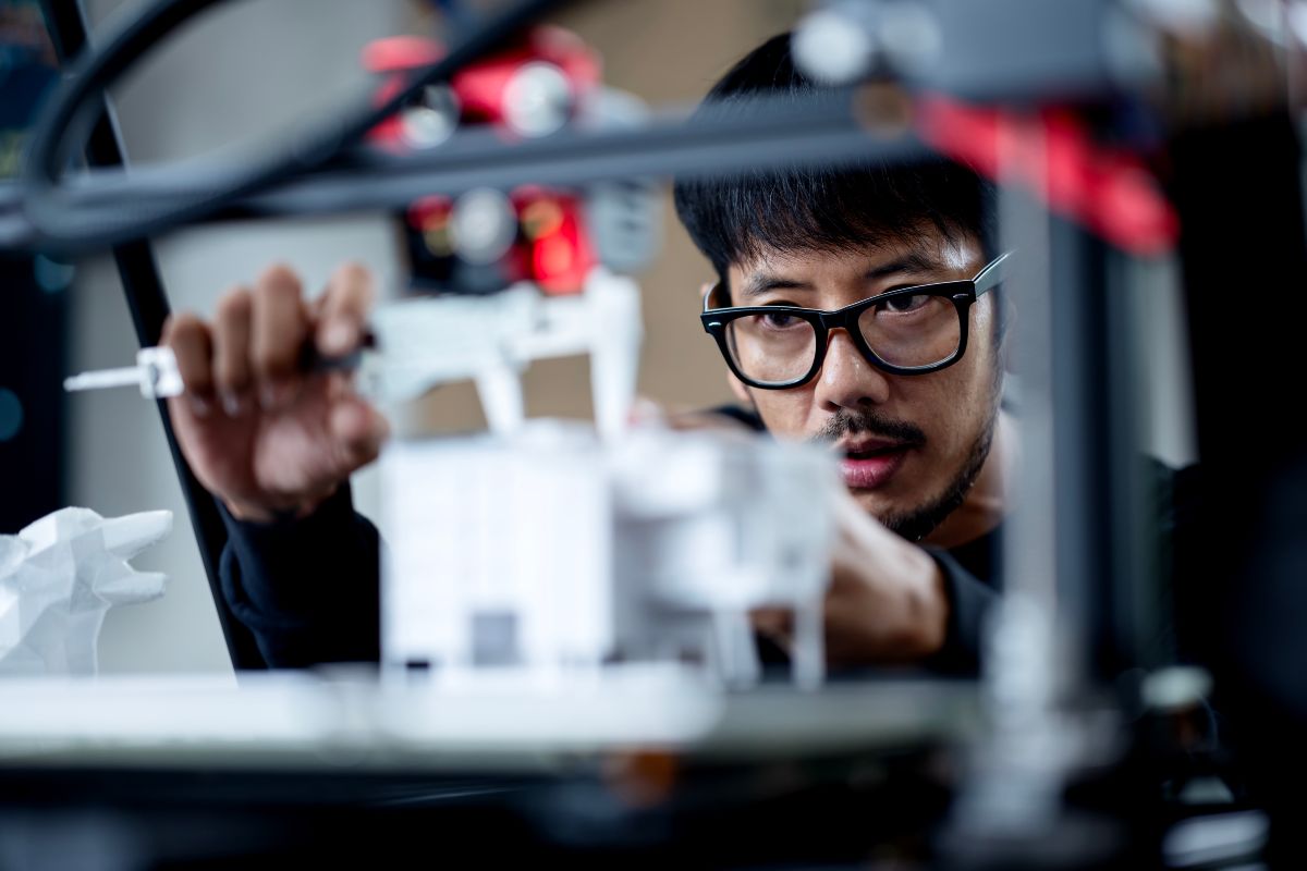 young person working with a 3D printer