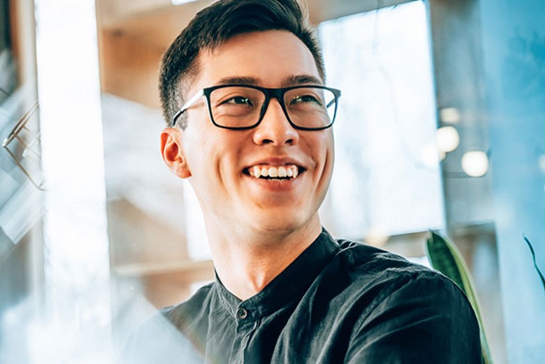 person smiling and looking to the right