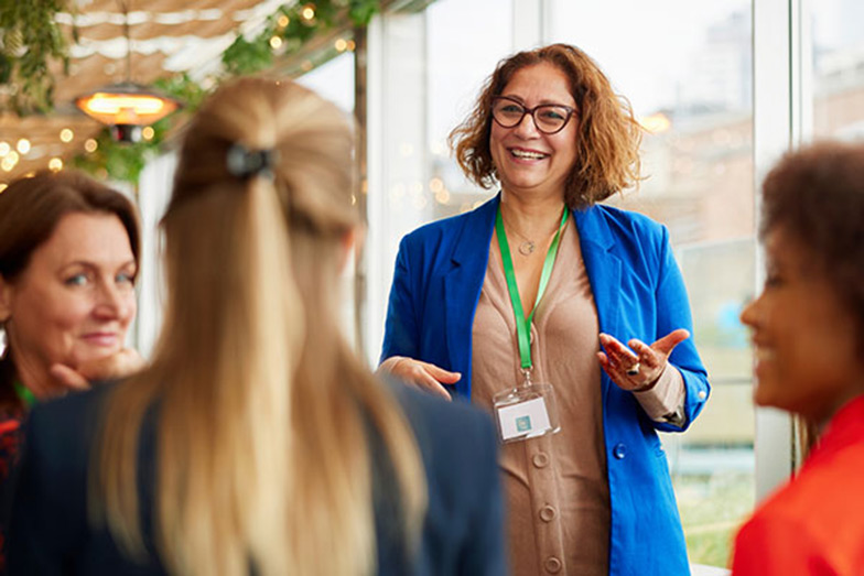 woman talking with group at conference