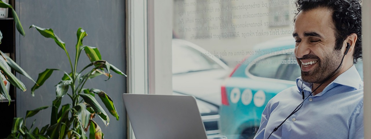 individual smiling at a laptop