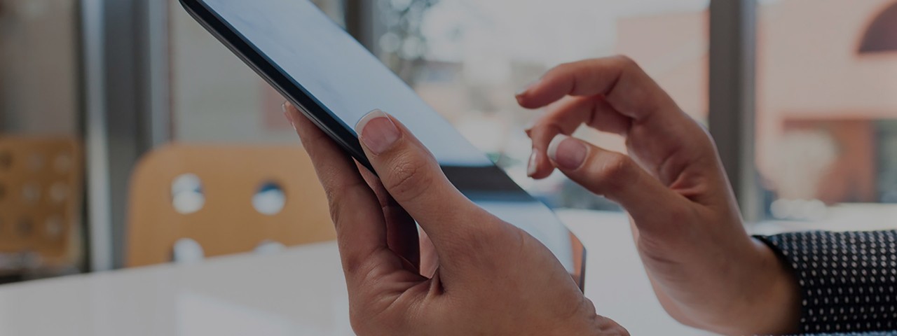 hands holding a tablet