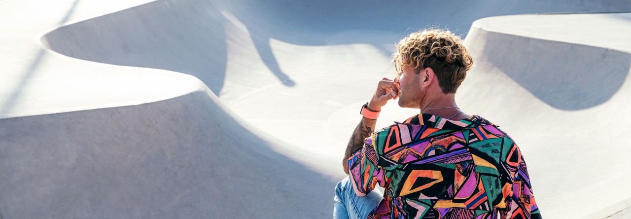 young person wearing colourful top at skatepark
