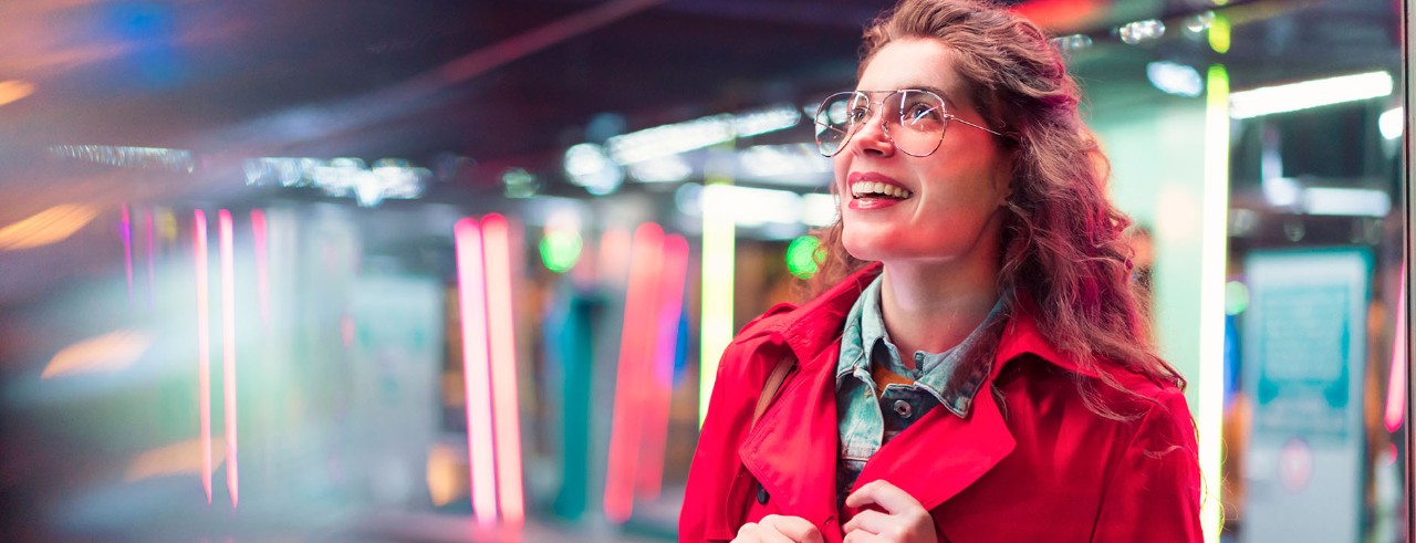 person smiling in urban setting