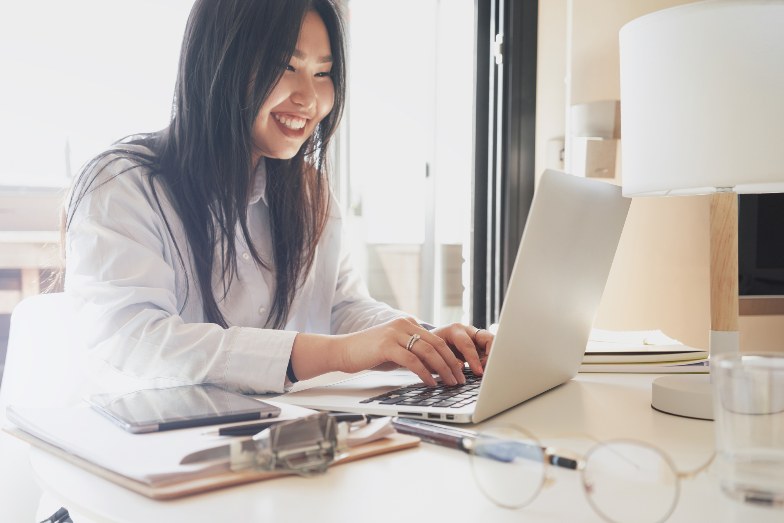 happy student typing on laptop