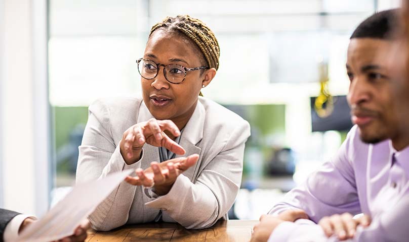 person gesticulating in a business meeting