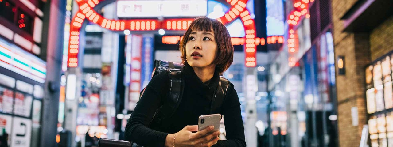 Person smiling with bike in urban setting
