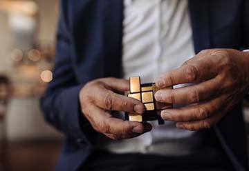 midsection of businessman using mobile phone in office