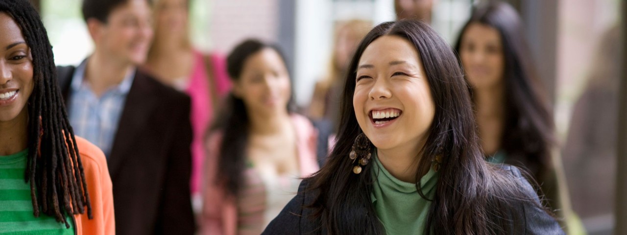 happy student leaving classroom with other students in the background
