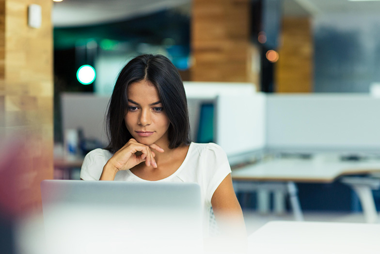 Woman looking at laptop