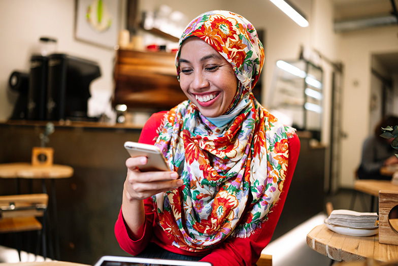 Person looking at phone and smiling