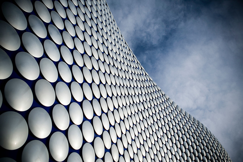 Round white discs rising up to cloudy sky