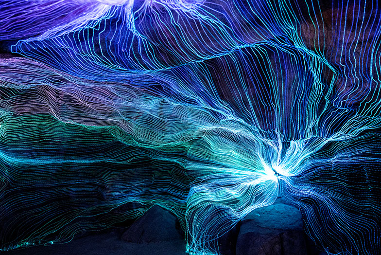 An abstract, futuristic computer-generated image showing lightwaves