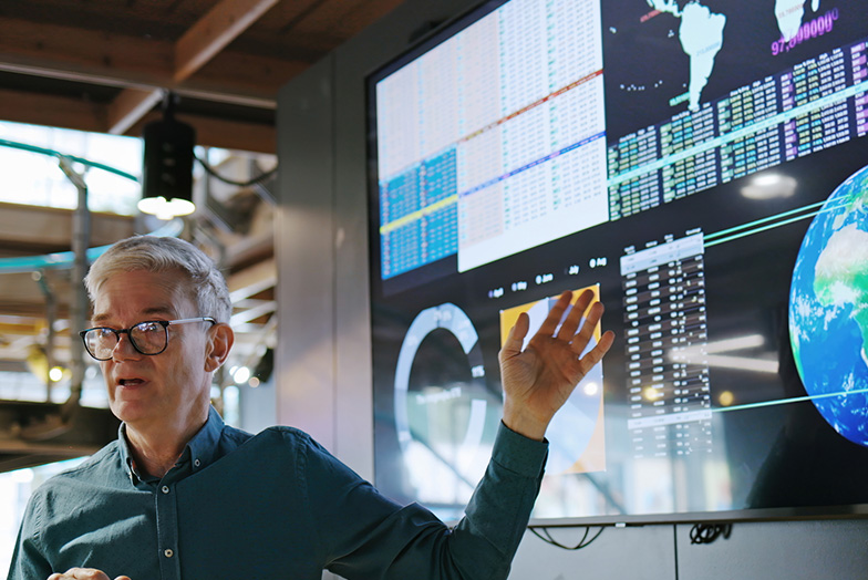 Person presenting in front of screen