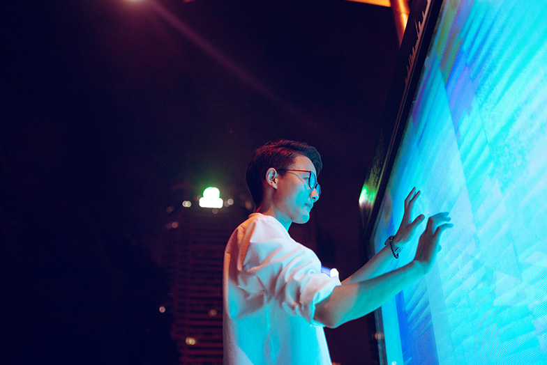 A person using a large touchscreen.