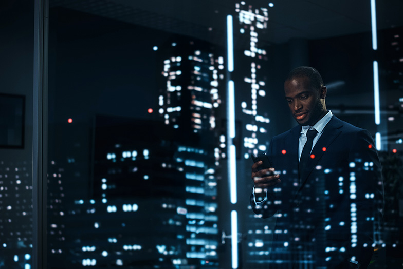 Business person looking out of a window in an office