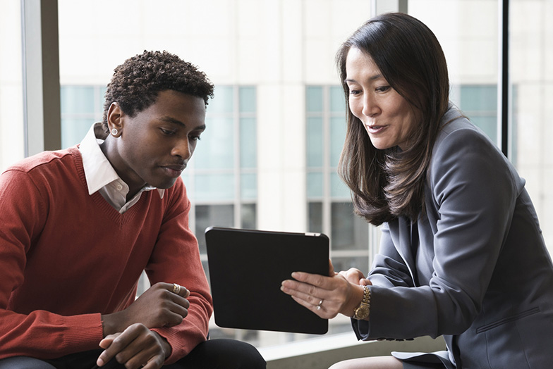 Two people looking at a tablet