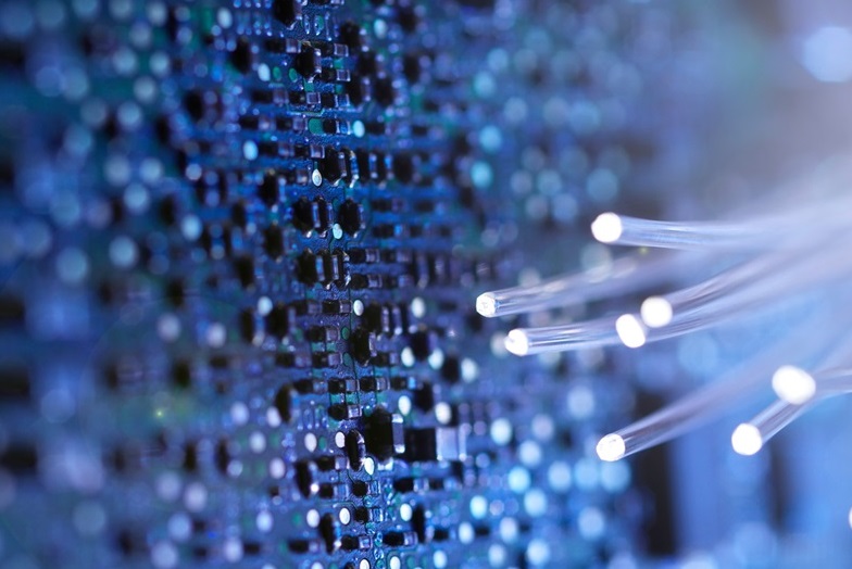 Close up of fibre optic strands and a circuit board