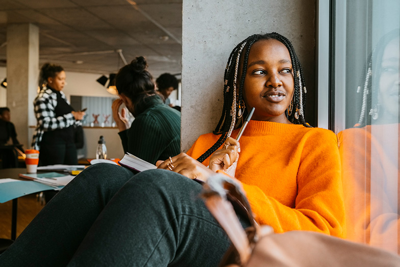 Person in office smiling looking outside window