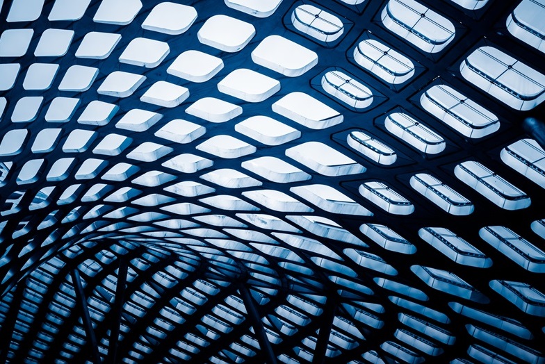 The skyward view through the windows of a futuristic building